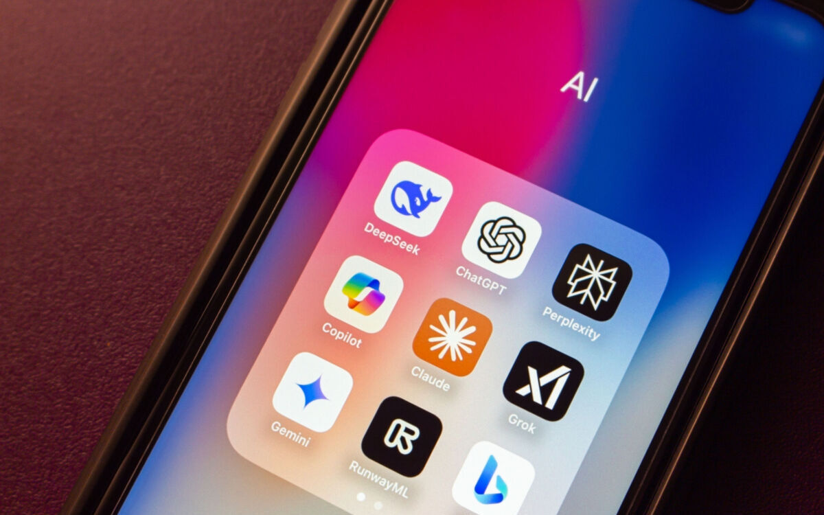 Iphone with AI Appllications like DeepSeek, ChatGPT, Perplexity, Copilot, Claude, Grok, Gemini, Runway ML and Bing icons are displayed on an iPhone. DeepSeek AI and Major AI services concept image.